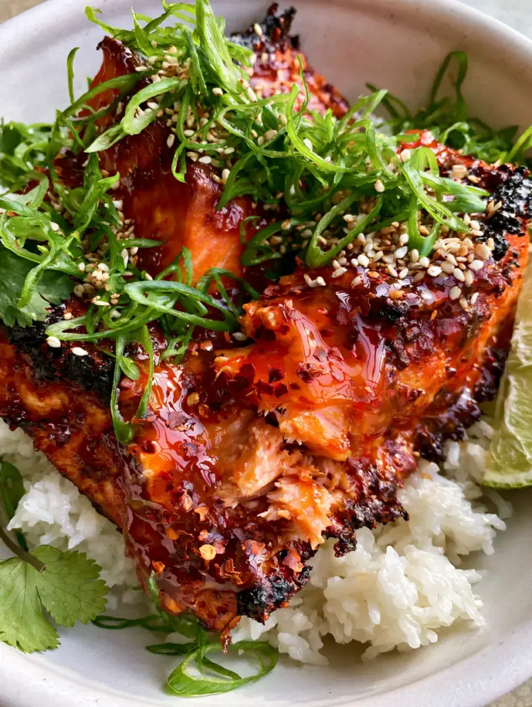 Firecracker Salmon: The Ultimate 15-Minute Air Fryer Glazed Salmon Bowl 1 Firecracker salmon fillets showing deep caramelized, dark edges from the air fryer convection heat.