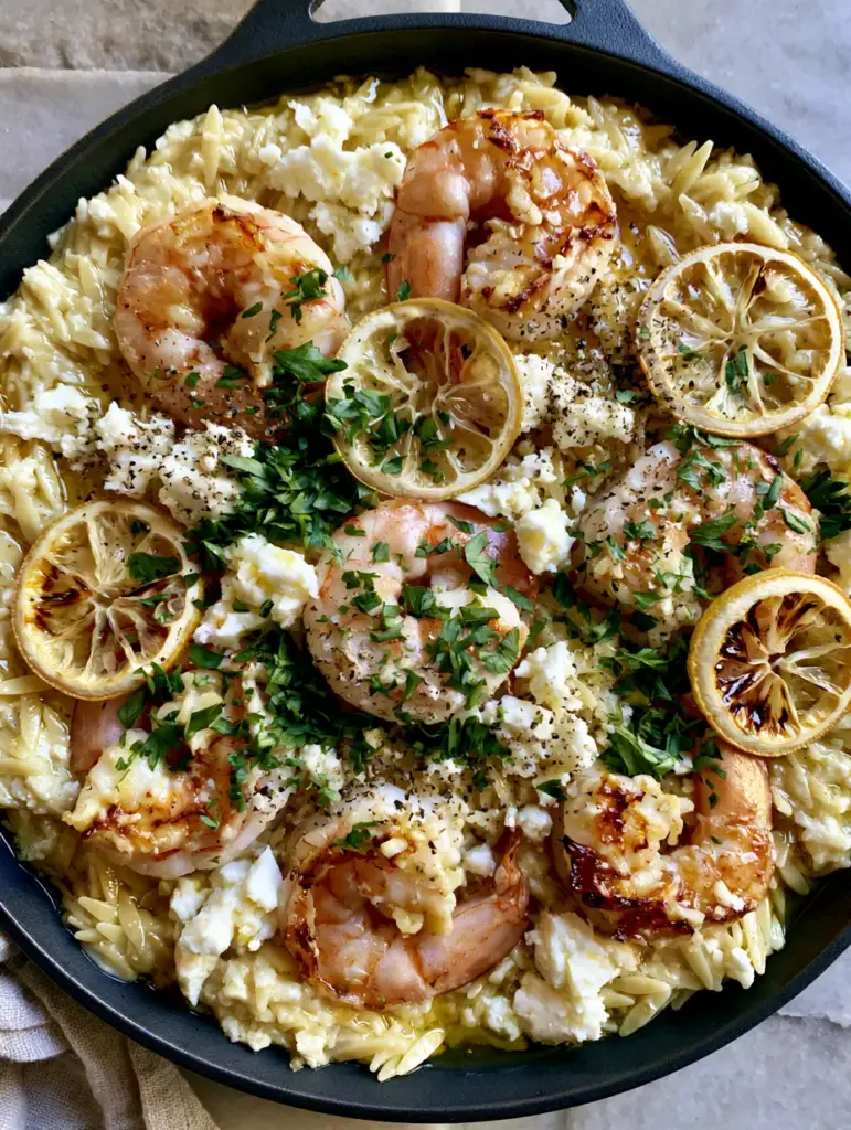 Lemon Feta Orzo Shrimp: The Ultimate One-Pan Mediterranean Skillet 2 Overhead view of Lemon Feta Orzo Shrimp in a cast iron pan, showing succulent seared shrimp and creamy pasta with herbs. (Lemon Feta Orzo Shrimp)