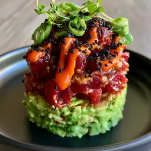 Macro photo of glistening ruby-red ahi tuna cubes in a soy-sesame glaze for tuna tartare. (tuna tartare)