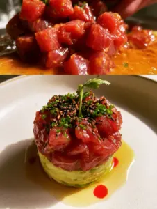 Close-up of ruby red tuna being tossed in glossy orange spicy miso sauce. (Nobu Tuna Tartare)