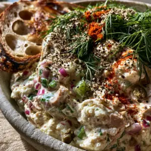 Macro close-up of creamy cottage cheese tuna salad showing flaky albacore, red onion jewels, and fresh dill sprigs. (cottage cheese tuna salad)